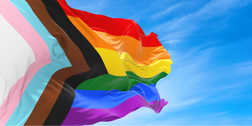 Progress pride flag against sky background