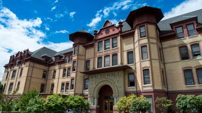 Front of Waldo Hall with view of deep blue sky & a few clouds