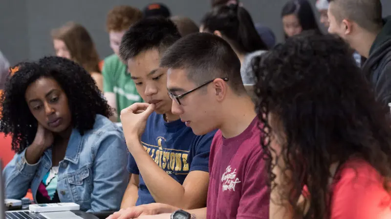 Group of diverse students sitting next to each other in a classroom