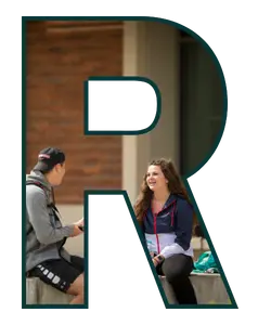 Letter R shaped frame with two college students chatting together outdoors