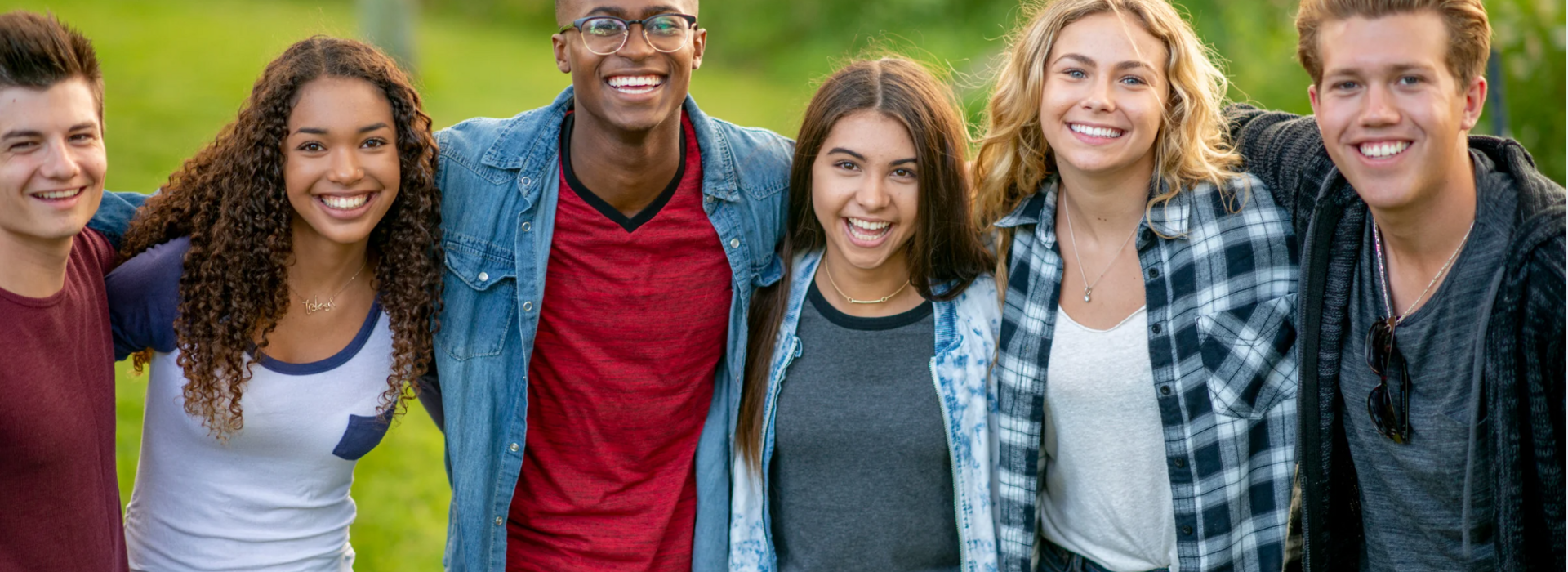 Diverse group of smiling young adults standing together