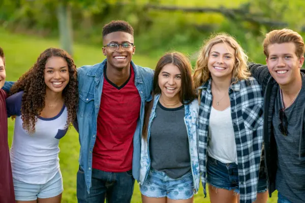 Diverse group of smiling young adults standing together